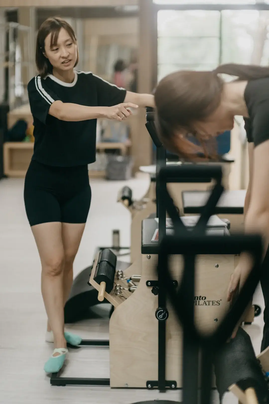 An instructor on the Reformer at RAIA Meruya, Jakarta